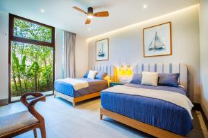 a bedroom with two beds and a window at Quiya Beach Residences in Cruz de Huanacaxtle +176 photos