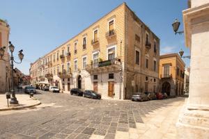 an empty street with a large brick building at DOMUS 73 Apulian holidays in Barletta