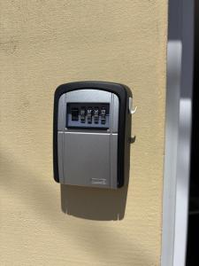 a soap dispenser on the side of a wall at Fresh Time Apartment in Kecskemét +8 photos
