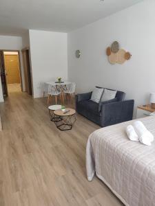 a living room with a bed and a couch at apartamentos YEIK in Muxia
