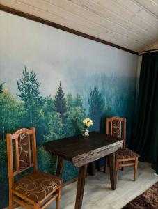 a dining room with a table and two chairs at FoxHome in Khashchovanoye