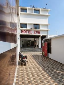 a motorcycle parked in front of a hotel eva at Hotel Eva Palace in Chatra +20 photos
