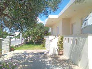 a white fence in front of a house at Irina Haus in Gerakini +38 photos
