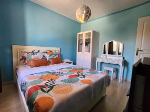 a bedroom with a bed with a colorful blanket at Le Ciel Bleu in Arles