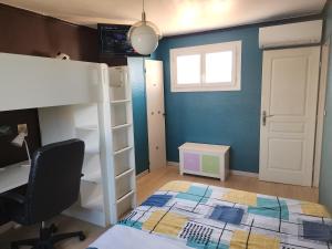 a bedroom with a bunk bed and a desk and a chair at Le Ciel Bleu in Arles +13 photos