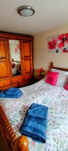 a bedroom with a bed with blue pillows on it at Comfortable Double Bedroom in Darlington