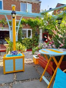 a patio with a table and a table and a playground at Comfortable Double Bedroom in Darlington