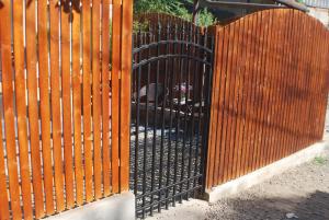 a wooden fence with a wooden gate with a heart at Garden Studio, Old Tbilisi in Tbilisi City +1 photo