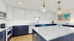 a kitchen with blue cabinets and a white counter top at Rehoboth Beach - 24 Brooklyn Ave Unit E in Rehoboth Beach