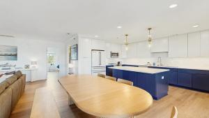 a kitchen and living room with a wooden table at Rehoboth Beach - 24 Brooklyn Ave Unit E in Rehoboth Beach +16 photos