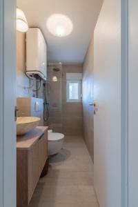 a bathroom with a sink and a toilet at Apartments Lučina in Bol +22 photos