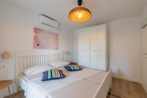 a bedroom with a bed with two pillows on it at Apartments Lučina in Bol