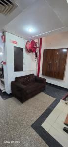a living room with a couch and a fire hydrant at Hotel Gareen By Du Rooms Near Delhi University Kamlangar in New Delhi