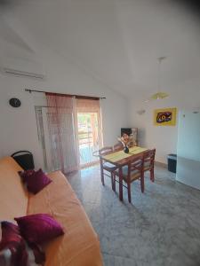 a living room with a couch and a table at Apartmani Ferri 2 in Vrbanj +8 photos