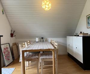 a dining room with a table and chairs and a kitchen at Vestervang 1, 8654 Bryrup in Bryrup