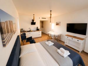 a bedroom with a large bed with two towels at AMD Apartamenty Ustka *** in Ustka