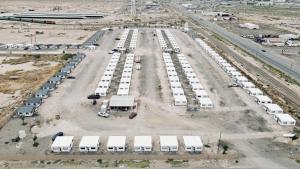 an aerial view of a parking lot with white trucks at Box Villages Pecos in Pecos