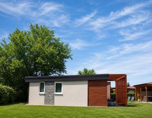 a small house with a gambrel roof at Fenyves Flow Apartman 1 in Balatonfenyves