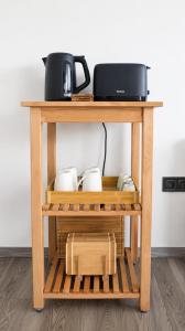 a wooden table with a microwave on top of it at Fenyves Flow Apartman 1 in Balatonfenyves