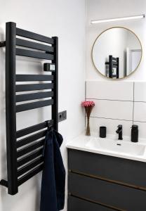 a bathroom with a sink and a mirror at Fenyves Flow Apartman 1 in Balatonfenyves