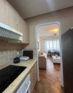 a kitchen with a stove top oven next to a living room at Blue Horizon in Cabo Negro