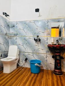 a bathroom with a toilet and a sink at Maa chamunda dham in Mathura