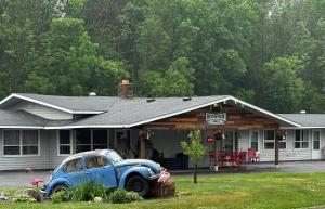 an old car parked in front of a house at Riverview Lodge in Cornell