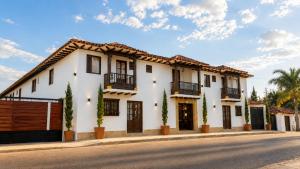 a white house with black windows and a street at Hotel Boutique & Spa - VDL Colonial in Villa de Leyva