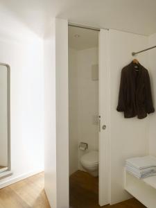 a bathroom with a toilet and a sliding glass door at Casa Navegna in Minusio +23 photos