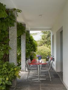 a dining table and chairs on a patio at Casa Navegna in Minusio