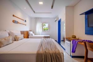 a bedroom with a large bed in a room at Vila Gallina Pousada in Jericoacoara