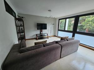a living room with a couch and a flat screen tv at Singular Sócrates in Mexico City