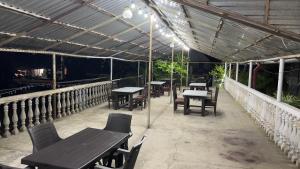 a patio with tables and chairs on a roof at Ararat in Ozurgetʼi +15 photos