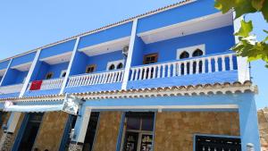 a blue building with a balcony at Stay with dkouk in Akchour