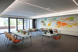 a conference room with tables and chairs and a large map at JUFA Hotel Werfenweng in Werfenweng +66 photos