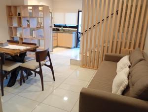 a living room with a couch and a table at Exclusive Dúplex Iguazú in Puerto Iguazú