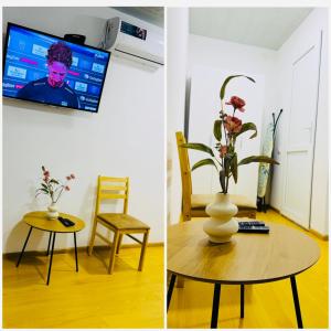 a living room with a table and a vase with flowers at MaVi House in Kutaisi
