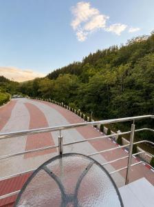 a glass bowl on a railing on a bridge at Balea Events in Cîmpeni