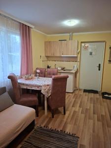 a kitchen and living room with a table and chairs at Villa Sunset in Palić