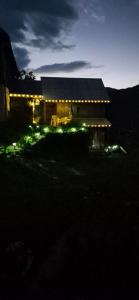 a house lit up at night with lights on it at Vikendica Iris in Mojkovac