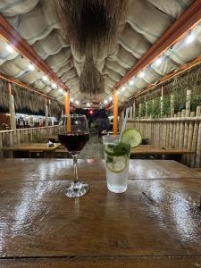 a glass of wine and a drink on a wooden table at Bach-Ana in Ureki
