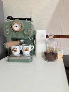 a coffee maker sitting on a counter with cups of coffee at Estudio en Villalonga in Pontevedra +6 photos