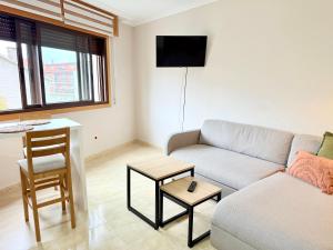 a living room with a couch and a table at Estudio en Villalonga in Pontevedra