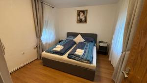 a bedroom with a bed with blue sheets and towels at Alina in Graz