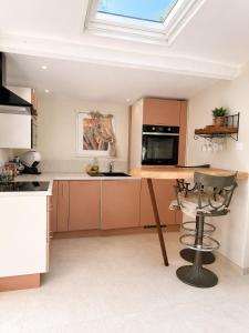 a kitchen with a wooden table and a skylight at Le Tiki Lodge in Fréjus