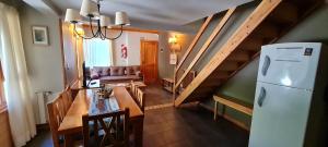 a living room with a table and a refrigerator at Matices Patagonicos in San Carlos de Bariloche