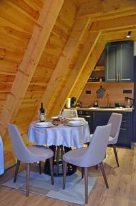a dining room with a table and chairs in a kitchen at Magic Forest Durmitor in Motički Gaj