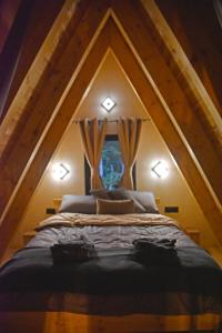 a bedroom with a bed in the attic at Magic Forest Durmitor in Motički Gaj