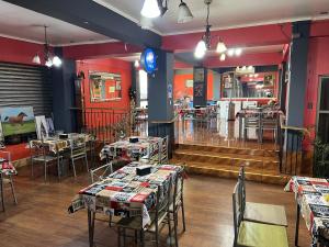 a restaurant with tables and chairs in a room at Hostal Rancel in Angol