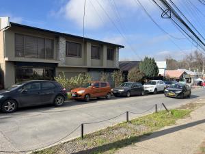 a group of cars parked on the side of a street at Hostal Rancel in Angol